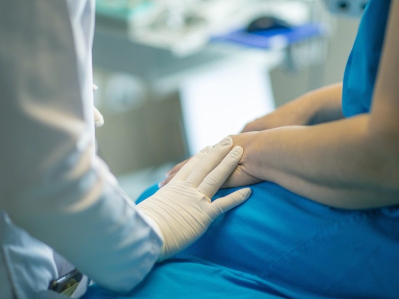 Ein Patient wird im Krankenhaus von einem Arzt im weißen Kittel untersucht.